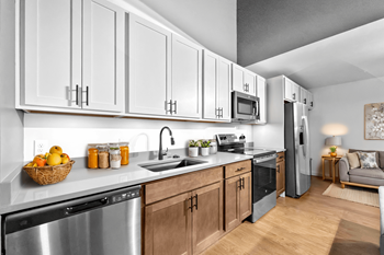A modern kitchen with wooden cabinets and stainless steel appliances.